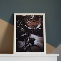 A modern room interior featuring a framed bicycle artwork with a cozy and artistic feel.